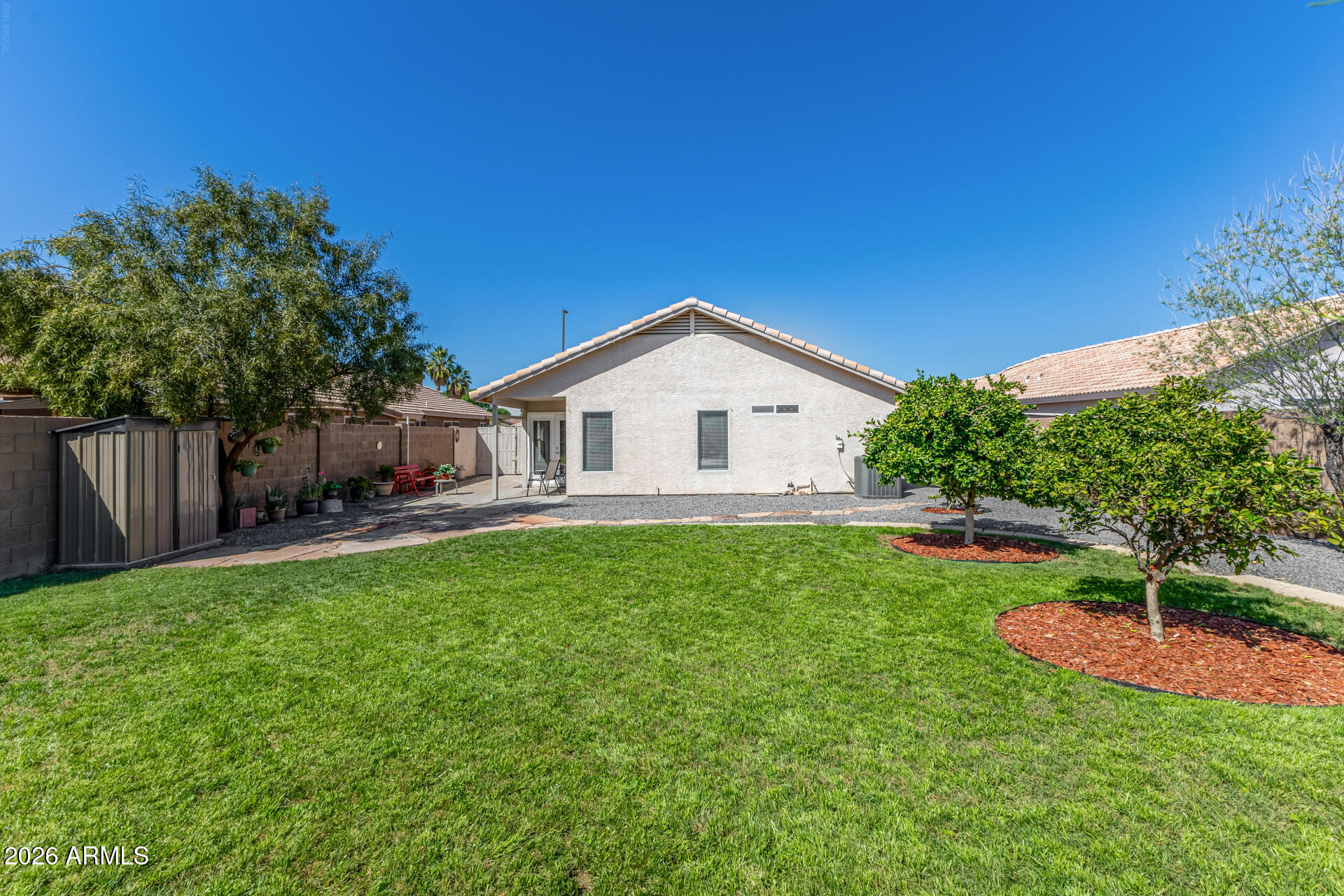 79 West Gail Drive Gilbert, AZ 85233 - Photo 6 of 37 Backyard, citrus trees gravel side