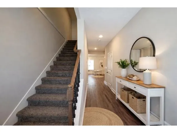 a view of entryway and hall with wooden floor