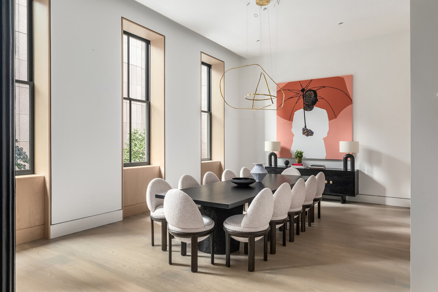 85 Worth Street, Unit 3 Manhattan, NY 10013 - Photo 4 of 14 a view of dining room and livingroom with furniture wooden floor a rug and a painting