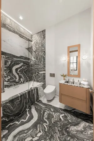 a bathroom with a tub sink and mirror