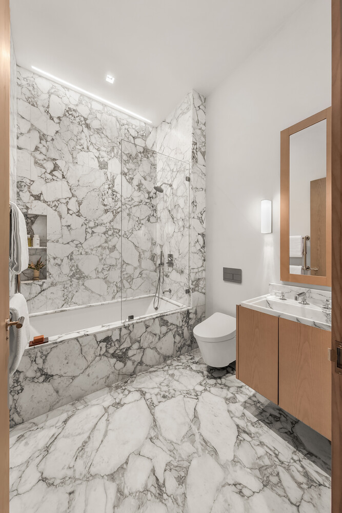 85 Worth Street, Unit 3 Manhattan, NY 10013 - Photo 8 of 14 a bathroom with a granite countertop sink a toilet and shower