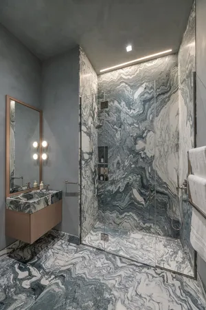 a bathroom with a granite countertop sink a toilet and shower