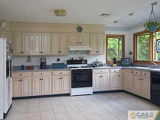 115 Hollow Road Skillman, NJ 08558 - Photo 3 of 8 a kitchen with granite countertop white cabinets white appliances a sink and a window