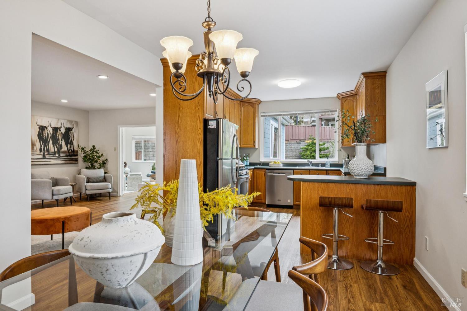 35 San Pablo Avenue San Rafael, CA 94903 - Photo 16 of 43 a dining room filled chandelier and wooden floor