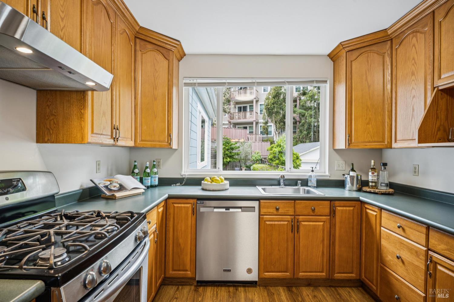 35 San Pablo Avenue San Rafael, CA 94903 - Photo 20 of 43 a kitchen with granite countertop a stove a sink and dishwasher wooden cabinets with granite countertops