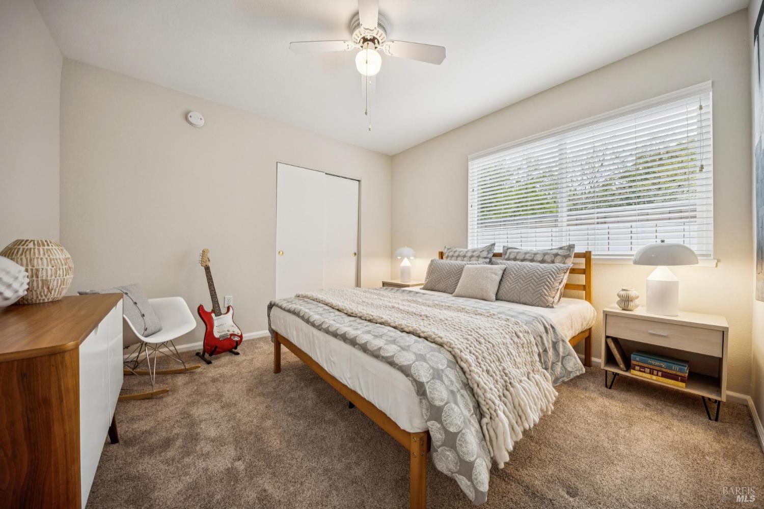 35 San Pablo Avenue San Rafael, CA 94903 - Photo 29 of 43 a spacious bedroom with a bed and a chandelier