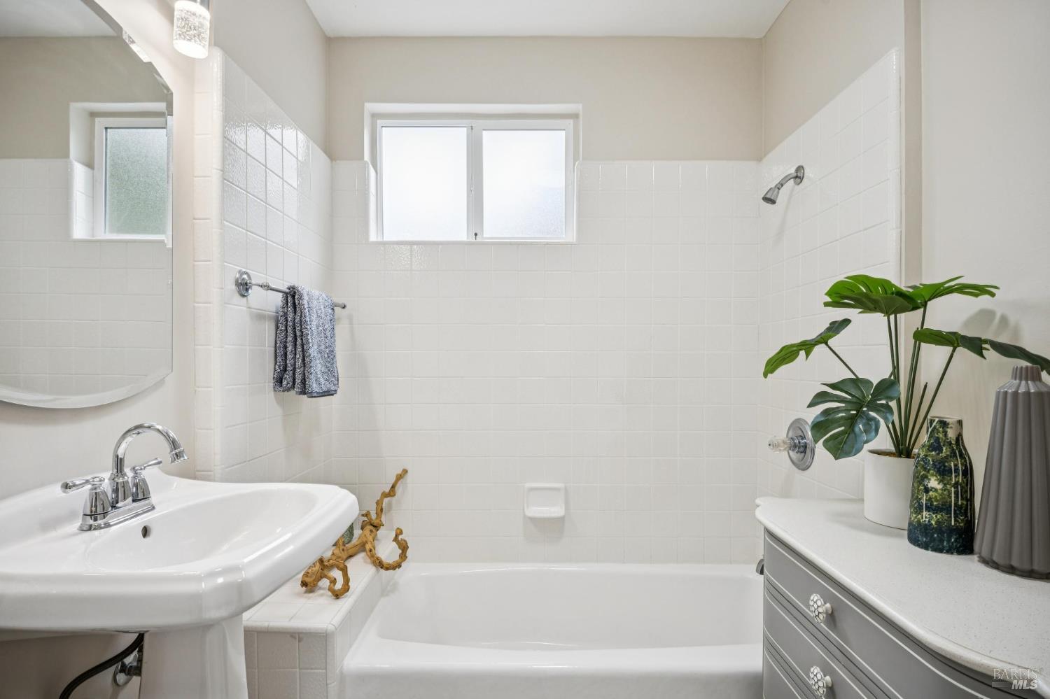 35 San Pablo Avenue San Rafael, CA 94903 - Photo 33 of 43 a bathroom with a sink a mirror and a bathtub