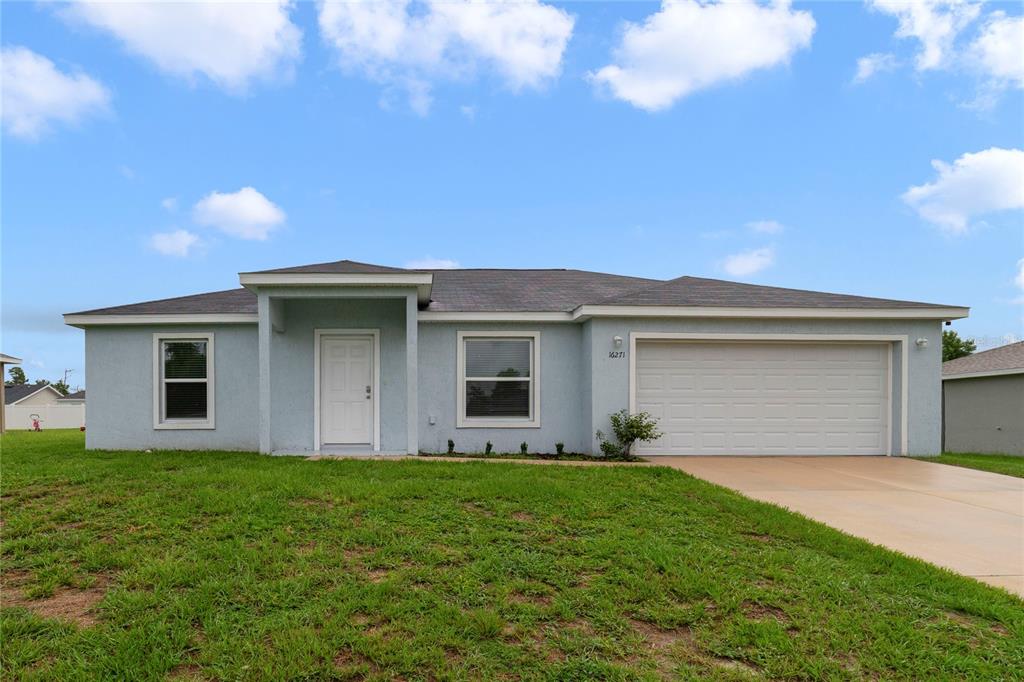16271 Southwest 27th Terrace Road Ocala, FL 34473 - Photo 1 of 21 a front view of a house with a garden and yard