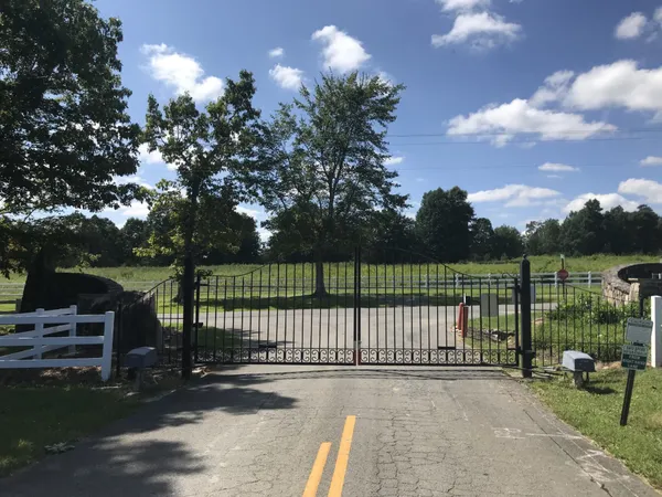a view of a park with iron fence