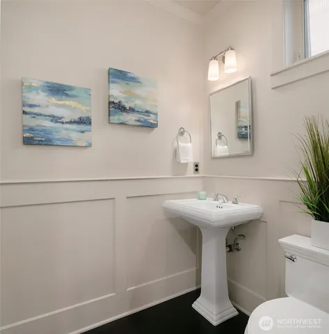 a bathroom with a sink mirror and toilet