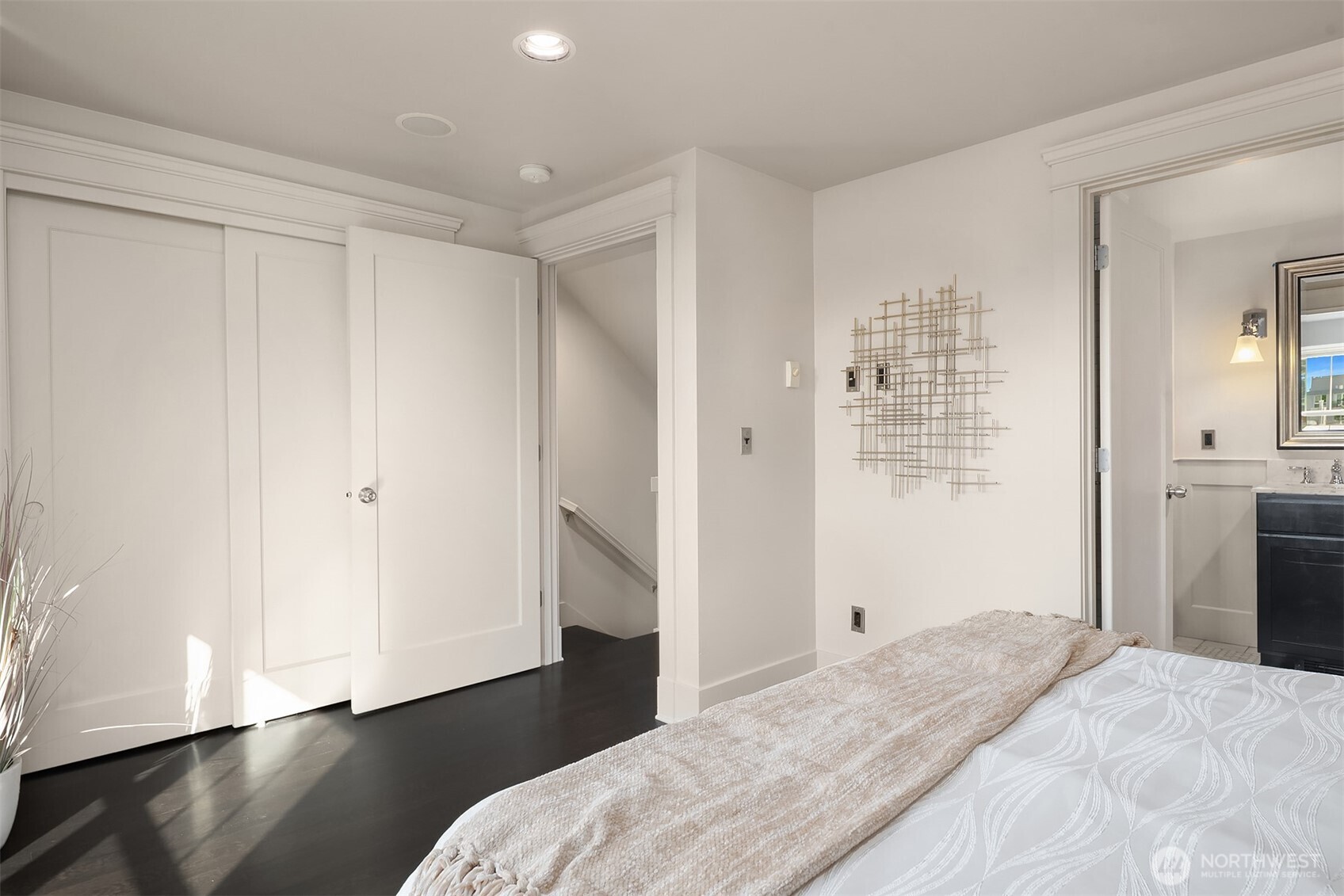 527 11th Avenue East, Unit A Seattle, WA 98102 - Photo 17 of 37 a bedroom with a bed and wooden floor