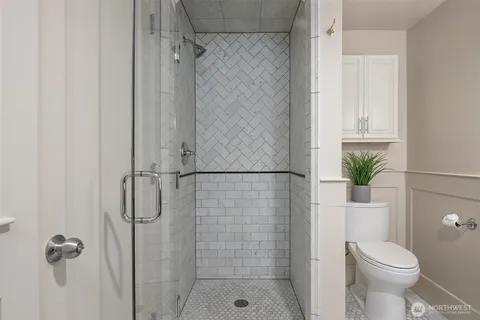 a bathroom with a shower and a toilet