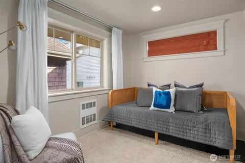 a bedroom with a bed and glass window