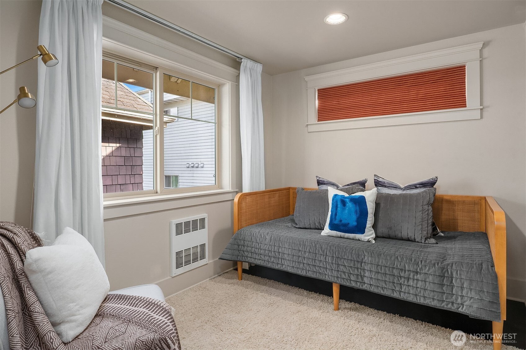 527 11th Avenue East, Unit A Seattle, WA 98102 - Photo 21 of 37 a bedroom with a bed and glass window