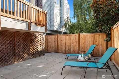a view of a chairs and table in a backyard