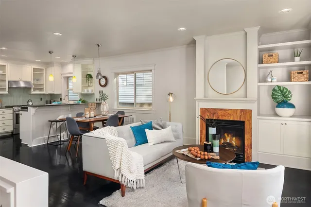 a living room with furniture a fireplace and a large window