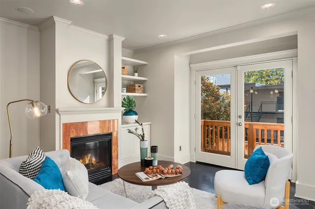 a living room with furniture a window and a fireplace