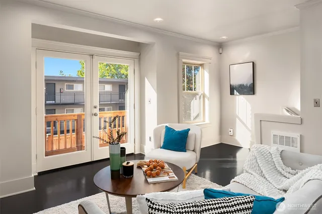 a living room with furniture a wooden floor and a large window