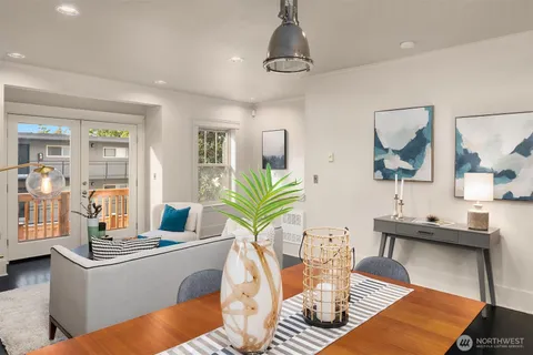 a living room with furniture a chandelier and a table