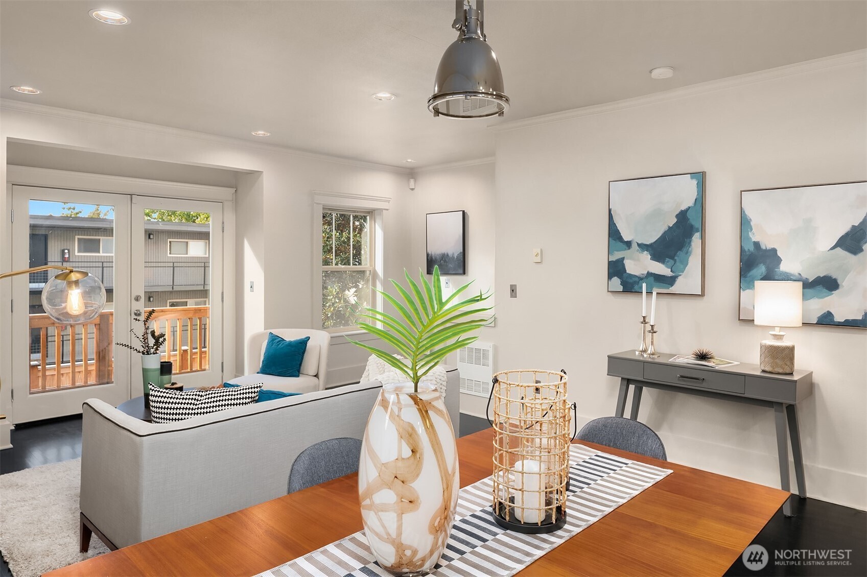 527 11th Avenue East, Unit A Seattle, WA 98102 - Photo 7 of 37 a living room with furniture a chandelier and a table