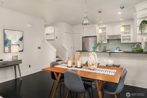 a view of a dining room with furniture and wooden floor