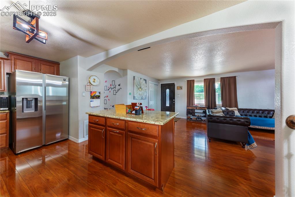 2205 Airport Road Colorado Springs, CO 80910 - Photo 14 of 40 a large living room with stainless steel appliances furniture a rug and a large window
