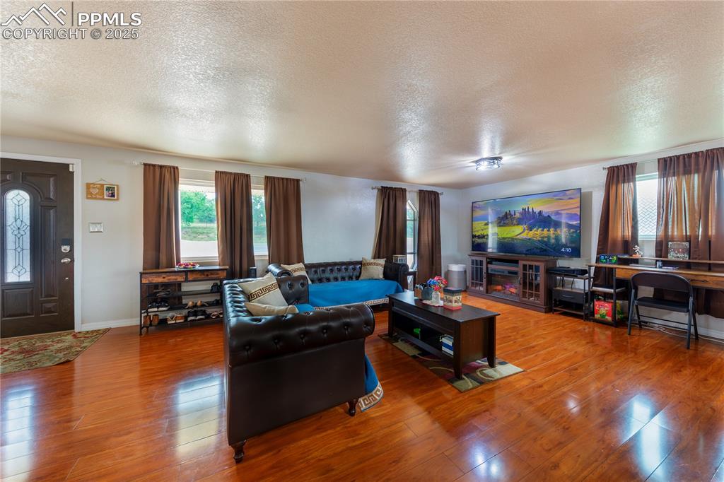 2205 Airport Road Colorado Springs, CO 80910 - Photo 16 of 40 a living room with furniture and a flat screen tv