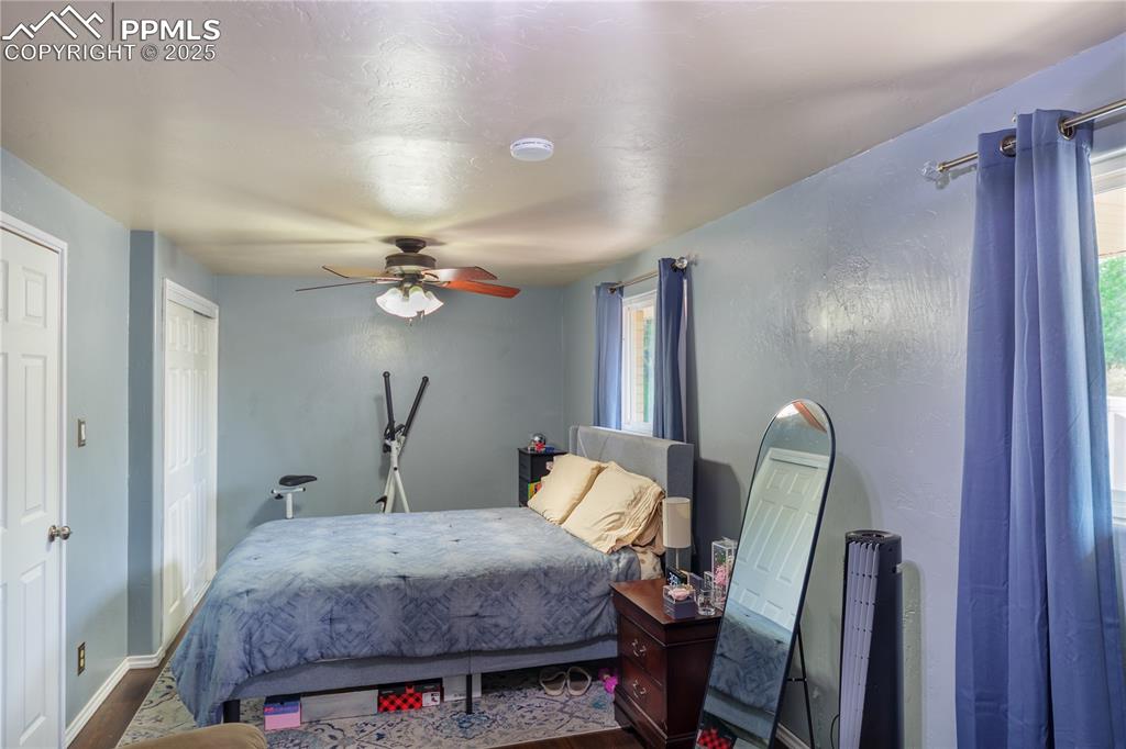 2205 Airport Road Colorado Springs, CO 80910 - Photo 20 of 40 a bedroom with a bed and a mirror