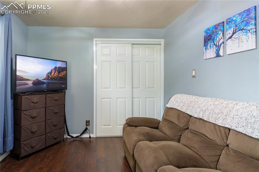 2205 Airport Road Colorado Springs, CO 80910 - Photo 21 of 40 a bedroom with furniture and a painting on the wall