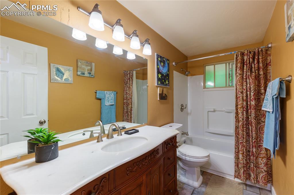 2205 Airport Road Colorado Springs, CO 80910 - Photo 23 of 40 a bathroom with a sink a toilet and shower