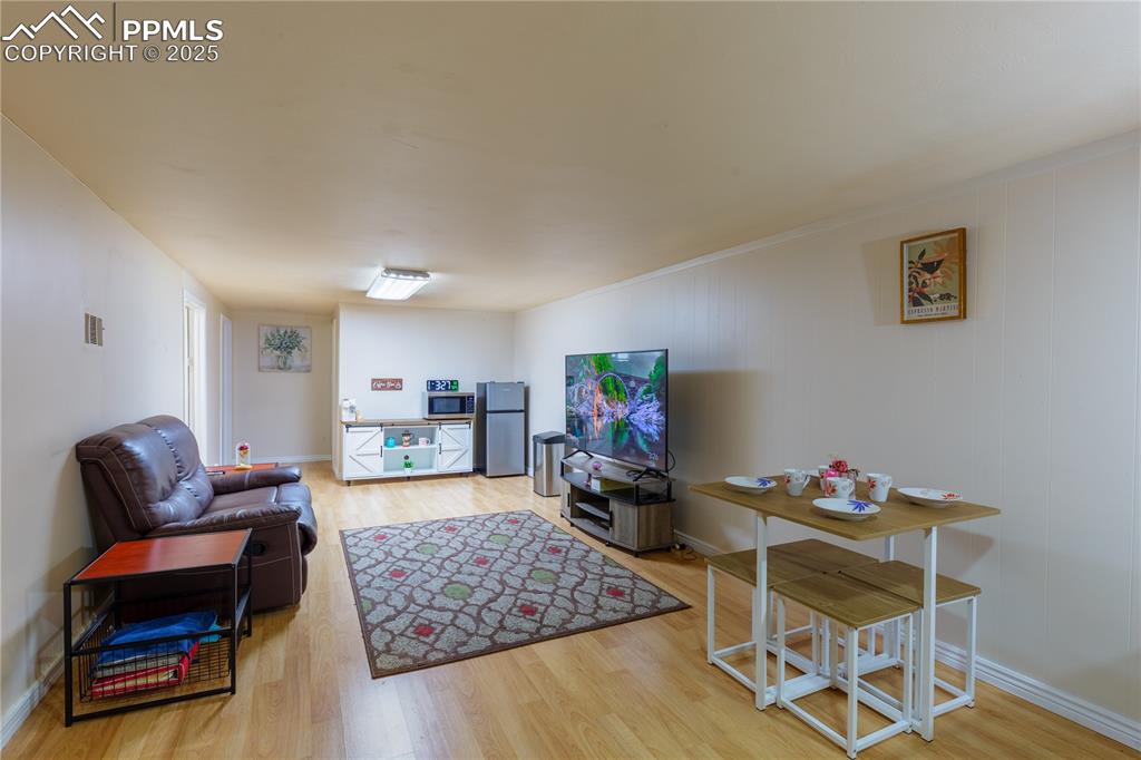 2205 Airport Road Colorado Springs, CO 80910 - Photo 24 of 40 a living room with furniture and a wooden floor