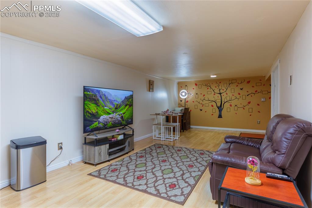 2205 Airport Road Colorado Springs, CO 80910 - Photo 26 of 40 a living room with furniture and a flat screen tv