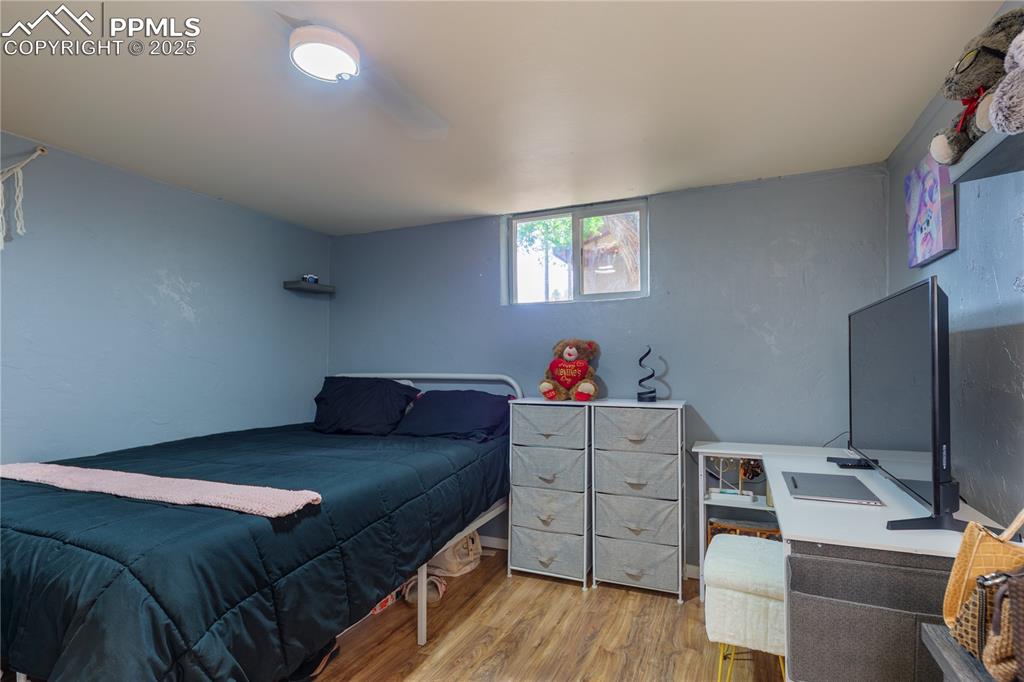 2205 Airport Road Colorado Springs, CO 80910 - Photo 27 of 40 a bedroom with a bed and a flat screen tv