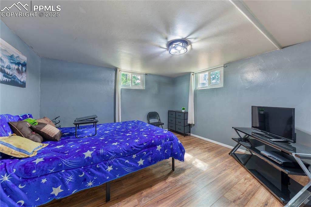 2205 Airport Road Colorado Springs, CO 80910 - Photo 30 of 40 a bedroom with a bed and a flat screen tv