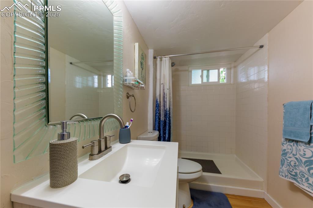 2205 Airport Road Colorado Springs, CO 80910 - Photo 31 of 40 a bathroom with a sink a toilet and shower