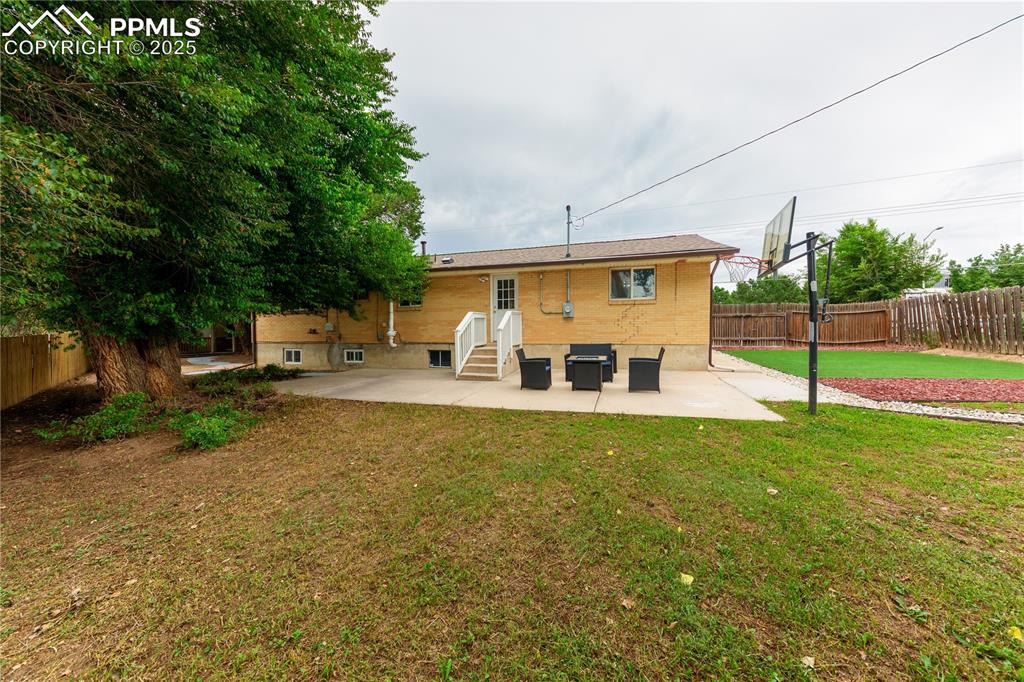 2205 Airport Road Colorado Springs, CO 80910 - Photo 34 of 40 a view of a house with backyard and a tree