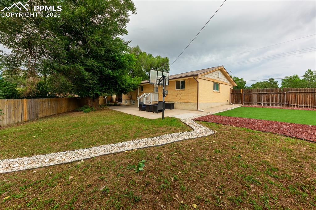 2205 Airport Road Colorado Springs, CO 80910 - Photo 35 of 40 a view of a house with a yard and sitting area