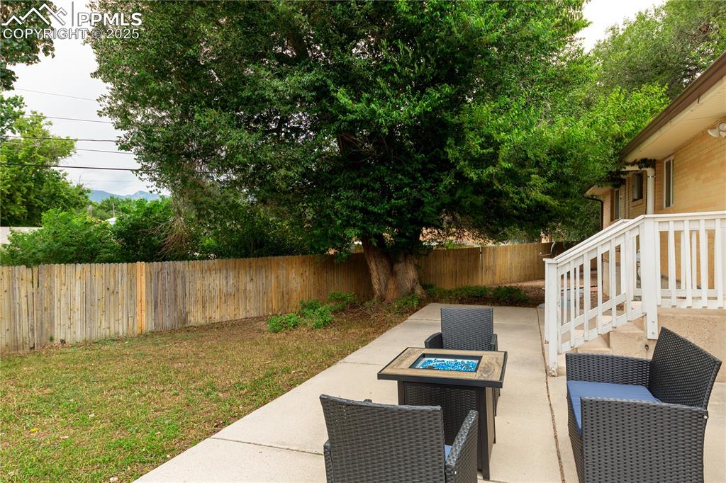 2205 Airport Road Colorado Springs, CO 80910 - Photo 37 of 40 a view of a patio with table and chairs with wooden floor and fence