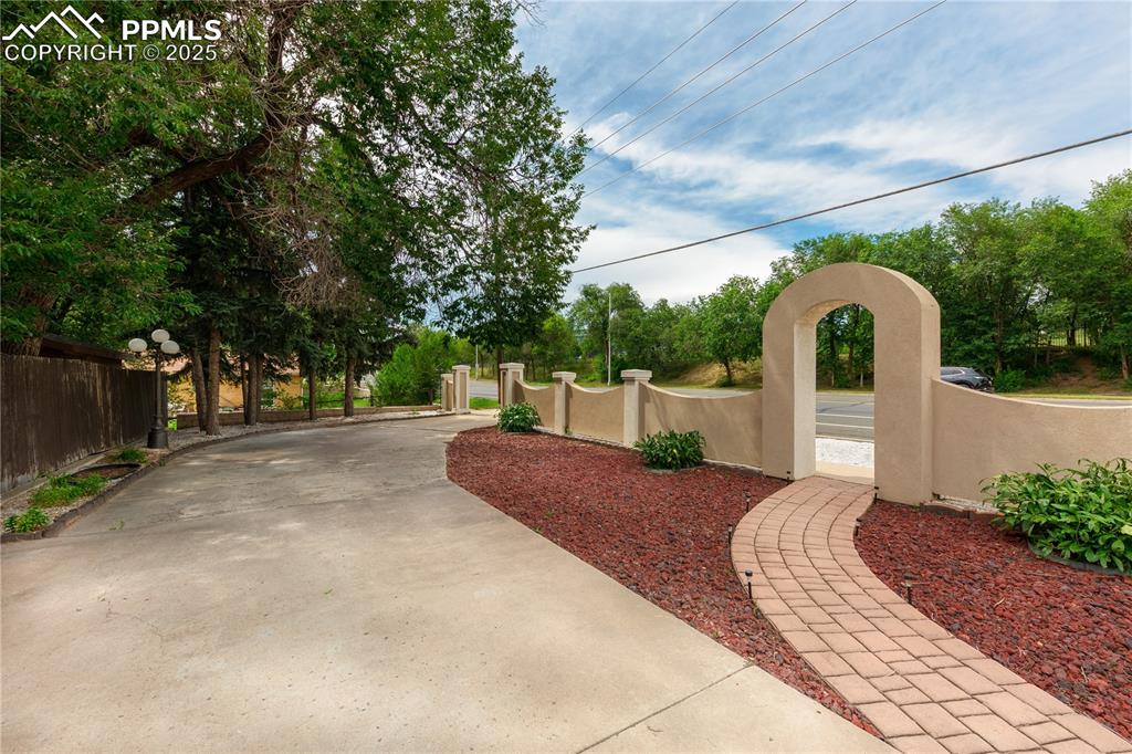 2205 Airport Road Colorado Springs, CO 80910 - Photo 4 of 40 a view of a back yard with flower plants and large tree