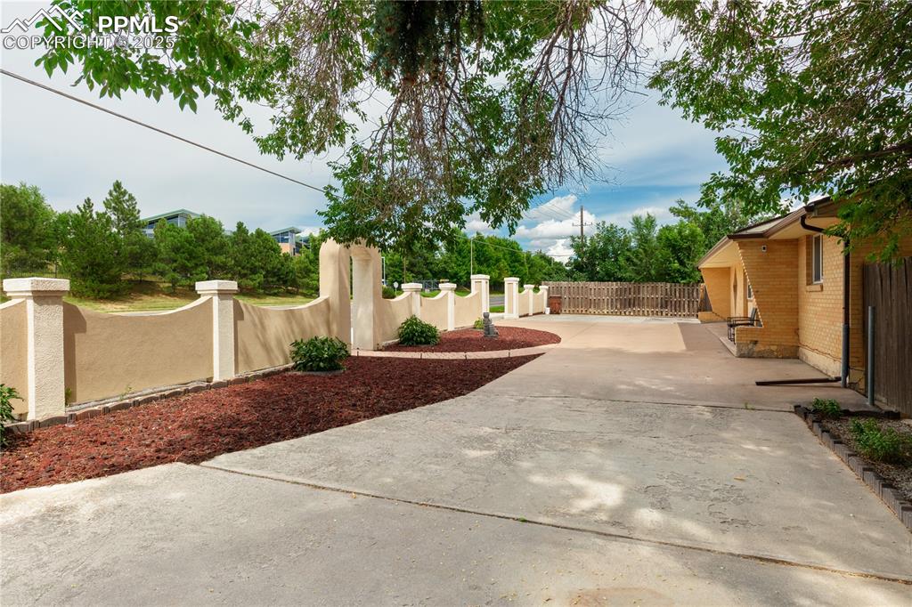 2205 Airport Road Colorado Springs, CO 80910 - Photo 5 of 40 a view of a patio with plants and a large tree