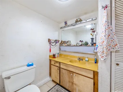 an empty room with painting on the wall and a window