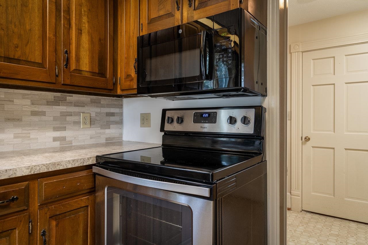 7231 Spring Creek Road Bridgewater, VA 22812 - Photo 19 of 74 a kitchen with granite countertop a stove and a microwave