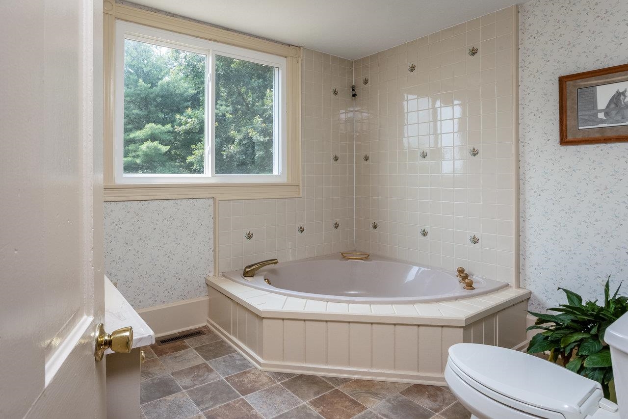 7231 Spring Creek Road Bridgewater, VA 22812 - Photo 24 of 74 a white bath tub sitting next to a toilet