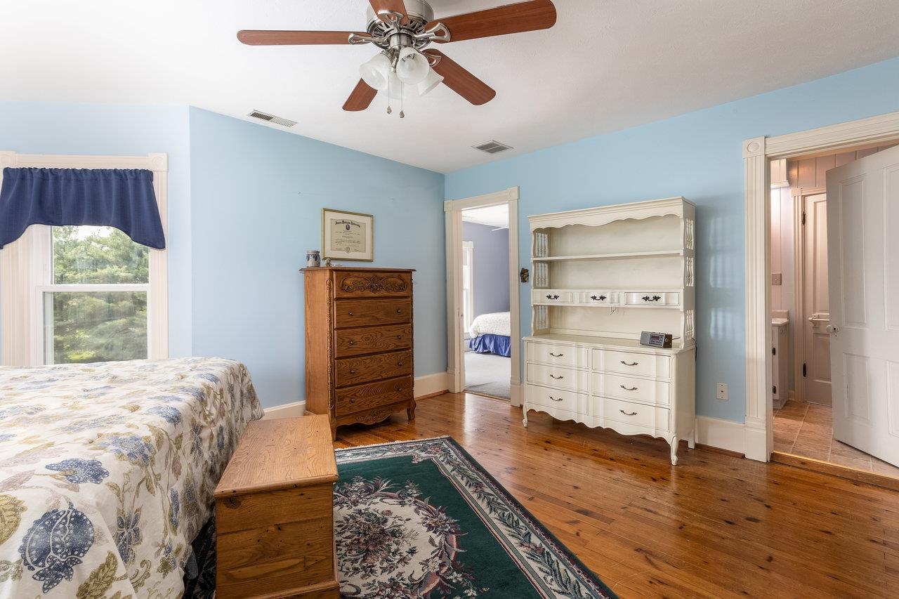 7231 Spring Creek Road Bridgewater, VA 22812 - Photo 30 of 74 a bedroom with a bed and wooden floor