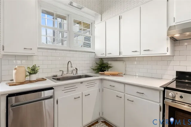 a kitchen with white cabinets and white appliances