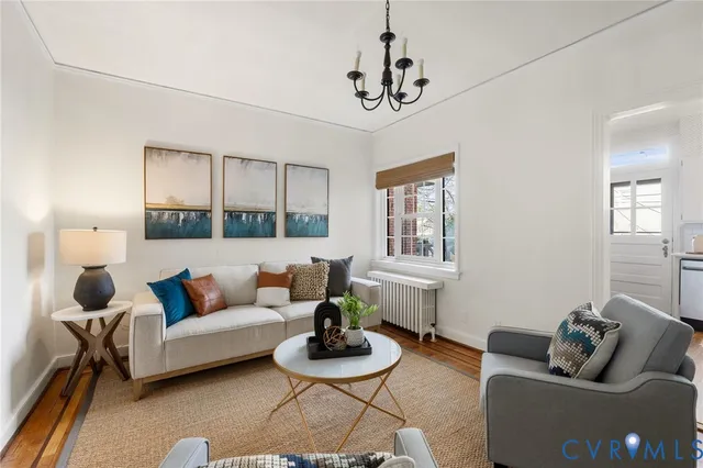a living room with furniture a rug and a window