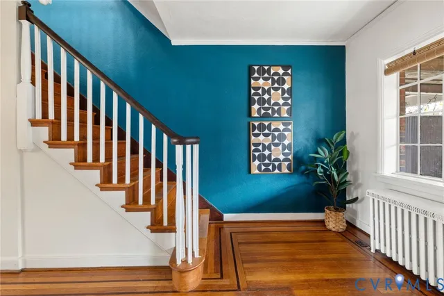 a view of staircase with wooden floor and a window