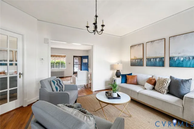 a living room with furniture and a chandelier