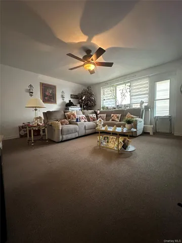 a living room with furniture chess table and a window
