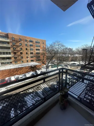 a view of a balcony with two chairs and a table